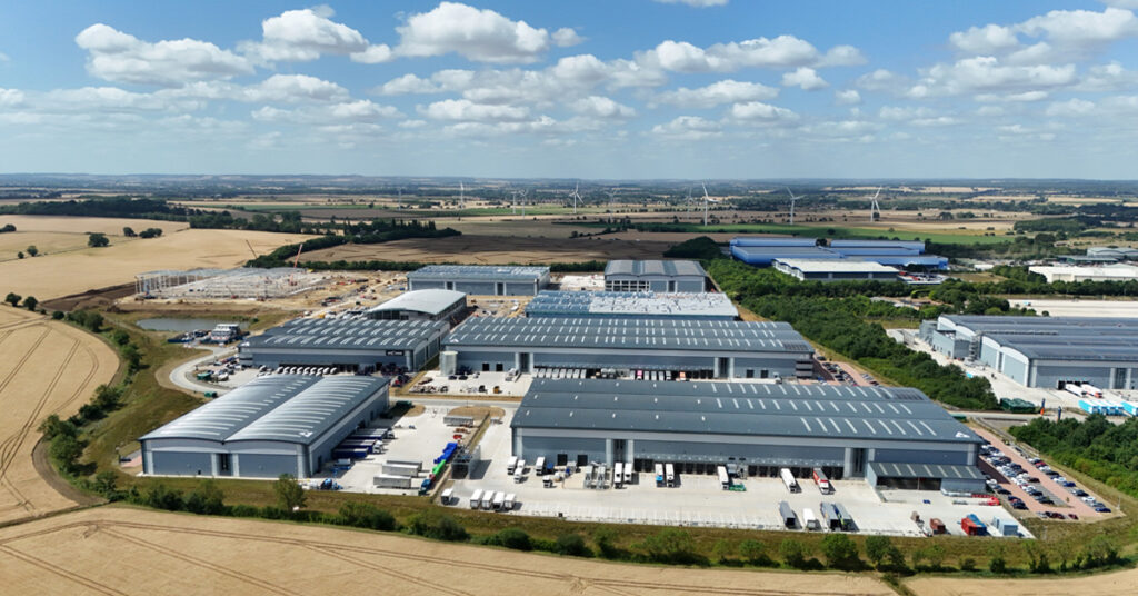Aerial shot of distribution warehouses and data center. Data center roofs benefit from continuous roof monitoring