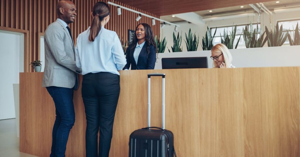 Two guest checking in at the reception counter of hotel